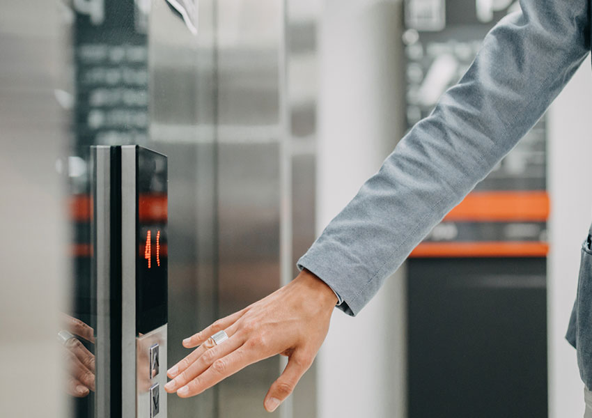 man pushing elevator buttons