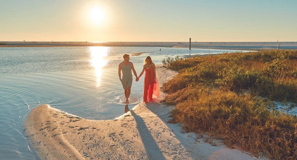 Couple on West Bay Beach at Sunset