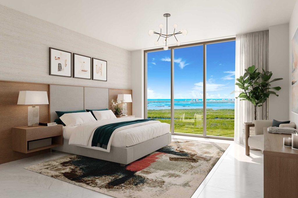 Bright primary bedroom at Island West Bay with floor to ceiling windows and expansive views of Estero Bay
