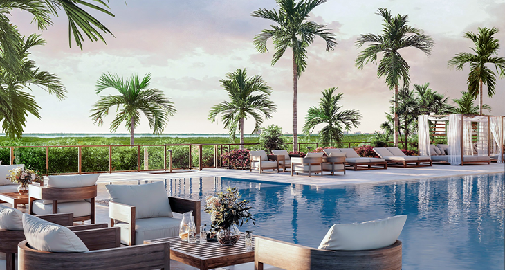 Resort-style pool with palm trees and lounge chairs